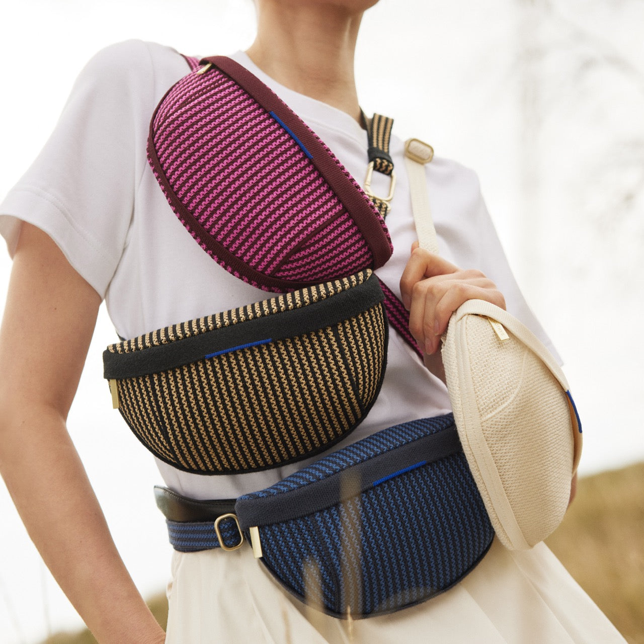 A model wearing four different colors of The Casual Sling.